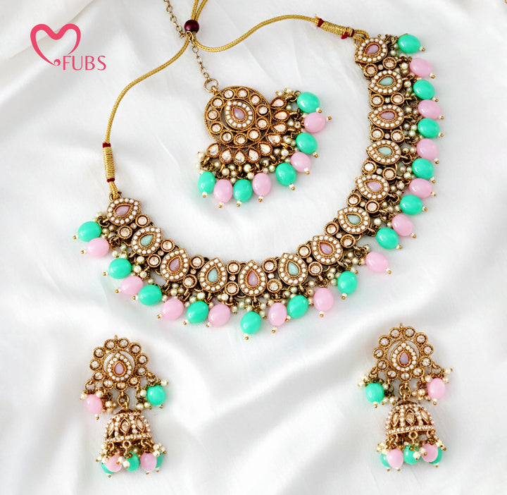Artisanal Floral Motif Gold-Finish Necklace Set with Jhumka Earrings & Maang Tikka